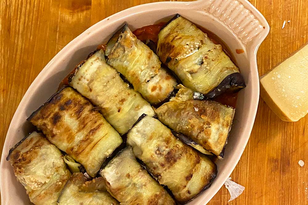 glamor shot of eggplant rollatini waiting to be topped with sauce