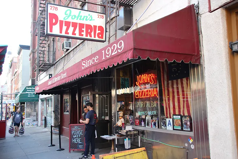 John's of Bleecker was founded in 1929 by John Sasso who once worked at Lombardi's. The double storefront has a neon sign