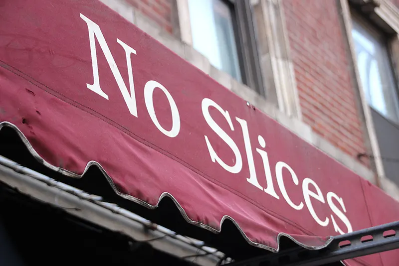 John's of Bleecker is famous for their NO SLICES policy, so much so that is on the sign on the awning above the shop