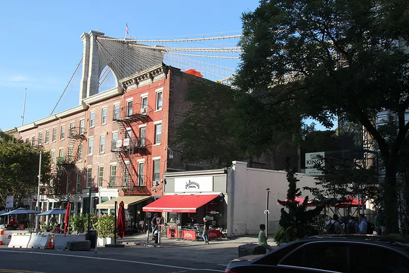 Juliana's in DUMBO with the Brooklyn Bridge towering over the building. The pizzeria was the original location of Grimaldi's, first called Patsy's, then Patsy Grimaldi's. Grimaldi's moved next door after a rent dispute