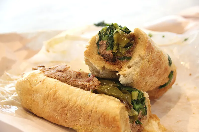 Philadelphia Italian roast pork sandwich from DiNic's in Reading Terminal Market with provolone cheese and broccoli rabe on a sesame seeded bun