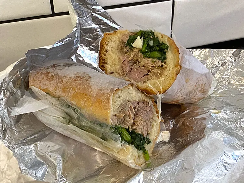 Fedoroff's of Brooklyn makes a Philadelphia Italian roast pork sandwich with provolone cheese and broccoli rabe on a sesame seeded bun