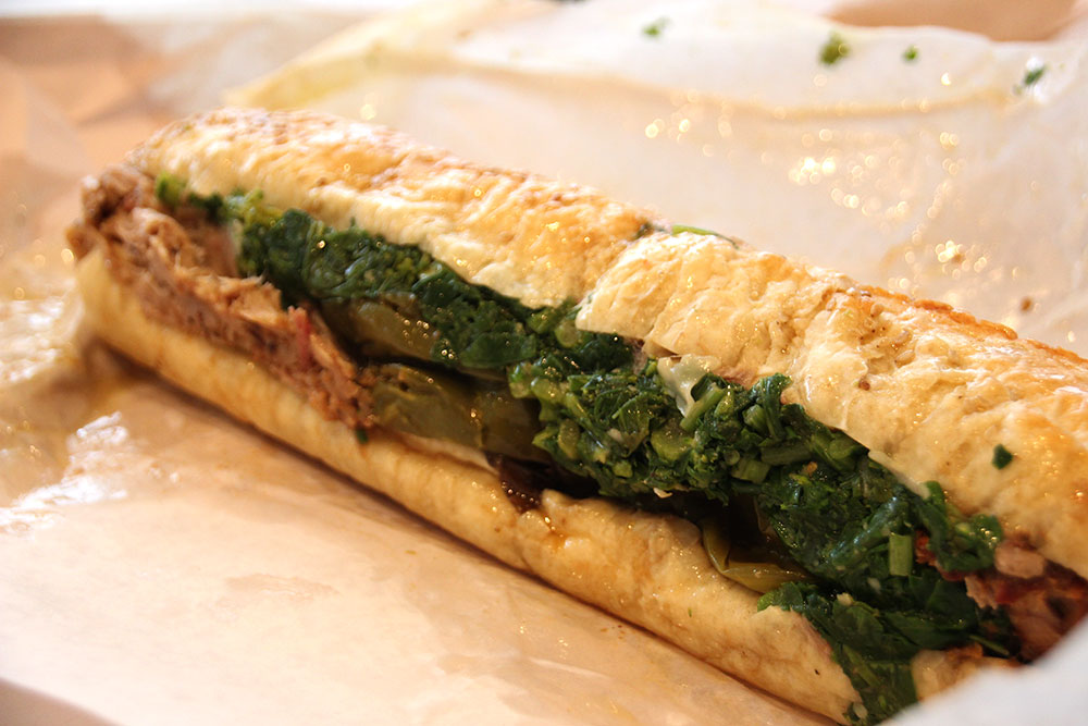 Philadelphia Italian roast pork sandwich from DiNic's in Reading Terminal Market with provolone cheese and broccoli rabe on a sesame seeded bun