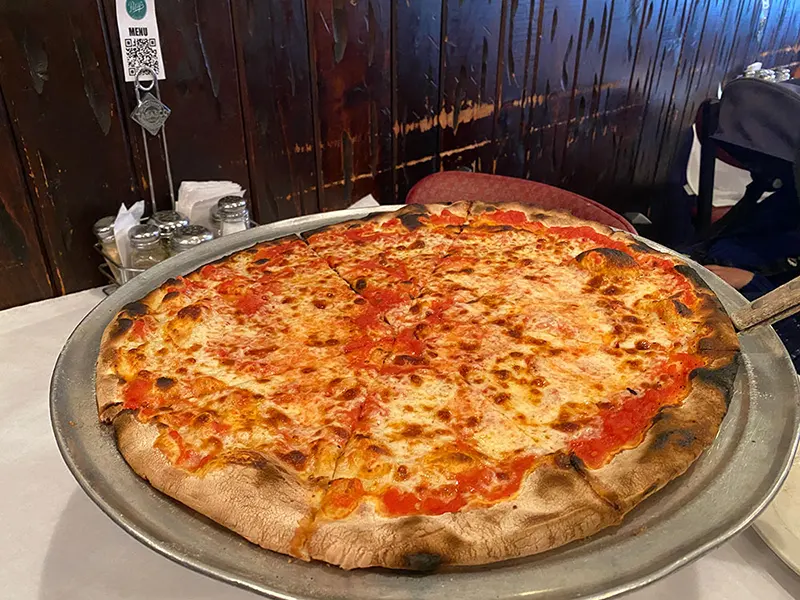 Patsy's whole pie, topped with cheese. This is a classic New York Slice that that is sturdy enough not to flop over on itself