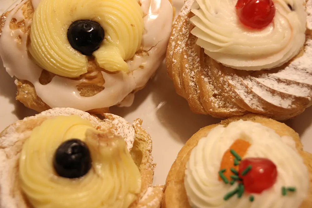 zeppole di San Giuseppe topped with cherries and candied fruit