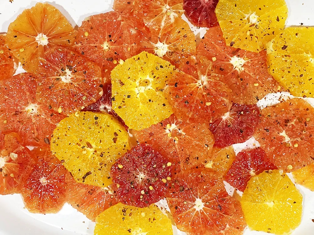 Sicilian style citrus salad with navel oranges, cara cara oranges, and blood oranges topped with red pepper